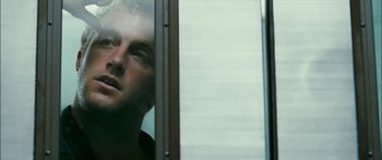 Movie still from “Into the Blue” (2005), directed by John Stockwell – A person looking out of a window; Close Up shot, Low angle