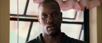 Movie still from “Into the Blue” (2005), directed by John Stockwell – A man's face in front of a window; Close Up shot, Low angle