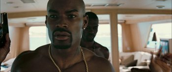 Movie still from “Into the Blue” (2005), directed by John Stockwell – A man with a gold chain around his neck; Close Up shot, Over the shoulder angle