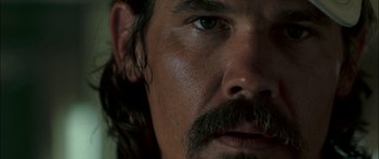 Movie still from “Into the Blue” (2005), directed by John Stockwell – A man with a beard and mustache; Extreme Close Up shot, Low angle
