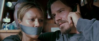 Movie still from “Into the Blue” (2005), directed by John Stockwell – A man and a woman with their mouths taped shut; Close Up shot, Over the shoulder angle