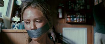 Movie still from “Into the Blue” (2005), directed by John Stockwell – A woman with duct tape over her mouth; Close Up shot, Over the shoulder angle