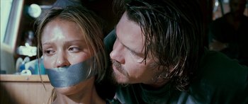 Movie still from “Into the Blue” (2005), directed by John Stockwell – A man and a woman with duct tape over their faces; Close Up shot, Low angle