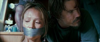 Movie still from “Into the Blue” (2005), directed by John Stockwell – A man and a woman with their mouths taped shut; Close Up shot, Low angle