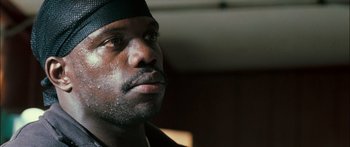 Movie still from “Into the Blue” (2005), directed by John Stockwell – A person wearing a hat; Close Up shot, Low angle