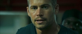 Movie still from “Into the Blue” (2005), directed by John Stockwell – A person wearing a blue t - shirt; Close Up shot, Over the shoulder angle