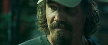 Movie still from “Into the Blue” (2005), directed by John Stockwell – A person with a hat and beard; Close Up shot, Over the shoulder angle