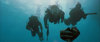 Movie still from “Into the Blue” (2005), directed by John Stockwell – A group of scuba divers swimming in the water; Wide shot, High angle