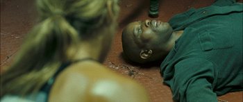 Movie still from “Into the Blue” (2005), directed by John Stockwell – A man laying on the ground looking up at another man; Close Up shot, High angle