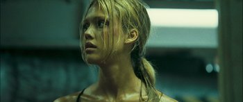Movie still from “Into the Blue” (2005), directed by John Stockwell – A young woman with long blonde hair is looking into the distance; Close Up shot, Low angle