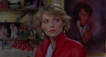 Movie still from “Into the Night” (1985), directed by John Landis – A person wearing a red jacket; Close Up shot, Over the shoulder angle