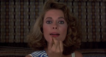 Movie still from “Into the Night” (1985), directed by John Landis – A person with her hand to her face; Close Up shot, Over the shoulder angle