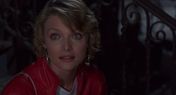 Movie still from “Into the Night” (1985), directed by John Landis – A person wearing a red jacket; Close Up shot, High angle