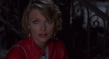 Movie still from “Into the Night” (1985), directed by John Landis – A person wearing a red jacket; Close Up shot, Over the shoulder angle