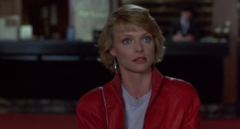 Movie still from “Into the Night” (1985), directed by John Landis – A person wearing a red jacket; Close Up shot, Over the shoulder angle