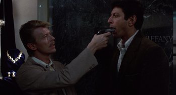 Movie still from “Into the Night” (1985), directed by John Landis – A man is brushing his teeth while another man is brushing his teeth; Close Up shot, Overhead angle