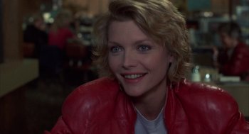 Movie still from “Into the Night” (1985), directed by John Landis – A person wearing a red leather jacket; Close Up shot, Over the shoulder angle