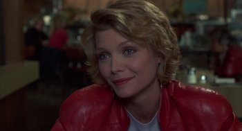 Movie still from “Into the Night” (1985), directed by John Landis – A person wearing a red jacket; Close Up shot, Over the shoulder angle