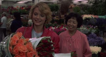 Movie still from “Into the Night” (1985), directed by John Landis – Two women are shopping at a flower market; Medium shot, Over the shoulder angle