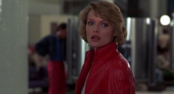 Movie still from “Into the Night” (1985), directed by John Landis – A person wearing a red leather jacket; Close Up shot, Over the shoulder angle