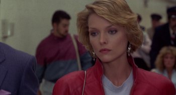 Movie still from “Into the Night” (1985), directed by John Landis – A person wearing a red leather jacket; Close Up shot, Over the shoulder angle