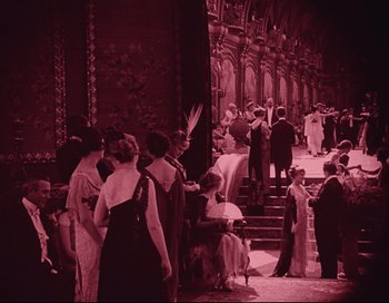 Movie still from “Intolerance” (1916), directed by D.W. Griffith – A group of people standing on steps in front of a building; Extreme Wide shot, High angle