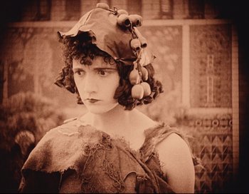 Movie still from “Intolerance” (1916), directed by D.W. Griffith – An old photograph of a woman wearing a wig; Close Up shot, Low angle