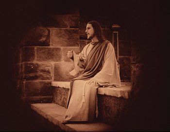 Movie still from “Intolerance” (1916), directed by D.W. Griffith – A man sitting on a step with a pipe in his mouth; Medium shot, Low angle