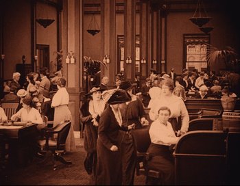 Movie still from “Intolerance” (1916), directed by D.W. Griffith – An old photo of people sitting at tables in a room; Wide shot, High angle