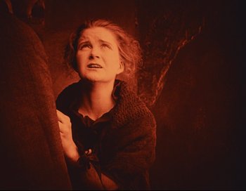 Movie still from “Intolerance” (1916), directed by D.W. Griffith – An old photo of a woman looking up to the sky; Medium shot, Low angle