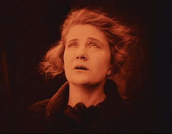 Movie still from “Intolerance” (1916), directed by D.W. Griffith – An older woman looking up into the sky; Close Up shot, Low angle
