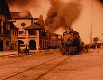 Movie still from “Intolerance” (1916), directed by D.W. Griffith – An old photo of a train going down the tracks; Extreme Wide shot, Low angle