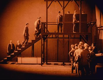 Movie still from “Intolerance” (1916), directed by D.W. Griffith – A group of men standing on top of a set of stairs; Extreme Wide shot, High angle