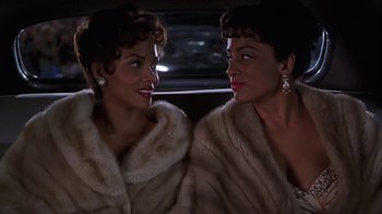 Movie still from “Introducing Dorothy Dandridge” (1999), directed by Martha Coolidge – A couple of women sitting next to each other in a car; Close Up shot, High angle