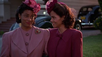 Movie still from “Introducing Dorothy Dandridge” (1999), directed by Martha Coolidge – Two young women in hats and jackets smiling for the camera; Close Up shot, Low angle
