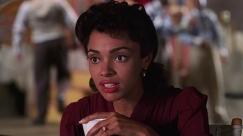 Movie still from “Introducing Dorothy Dandridge” (1999), directed by Martha Coolidge – A person holding a cup of coffee; Close Up shot, Over the shoulder angle