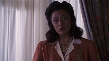 Movie still from “Introducing Dorothy Dandridge” (1999), directed by Martha Coolidge – An african american woman in a brown jacket; Close Up shot, Low angle