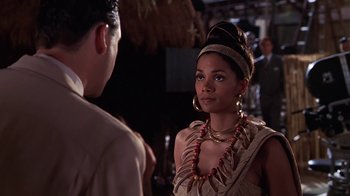 A woman in a native american outfit talking to a man