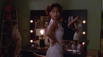 Movie still from “Introducing Dorothy Dandridge” (1999), directed by Martha Coolidge – A woman in a white dress in front of a mirror; Medium shot, Over the shoulder angle