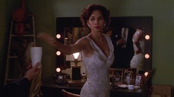Movie still from “Introducing Dorothy Dandridge” (1999), directed by Martha Coolidge – A woman in a white dress in front of a mirror; Medium shot, Over the shoulder angle