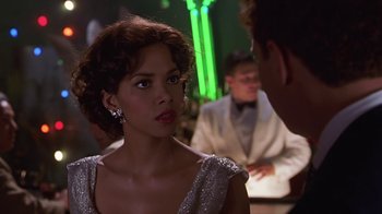 Movie still from “Introducing Dorothy Dandridge” (1999), directed by Martha Coolidge – A woman in a silver dress looking at a man in a white suit; Close Up shot, Over the shoulder angle