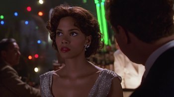 Movie still from “Introducing Dorothy Dandridge” (1999), directed by Martha Coolidge – A woman in a silver dress; Close Up shot, Over the shoulder angle