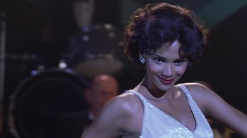 Movie still from “Introducing Dorothy Dandridge” (1999), directed by Martha Coolidge – A woman in a white dress is posing for a picture; Close Up shot, Low angle