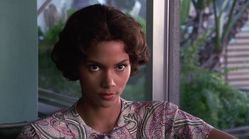 Movie still from “Introducing Dorothy Dandridge” (1999), directed by Martha Coolidge – A young woman with brown hair wearing a floral shirt; Close Up shot, Low angle