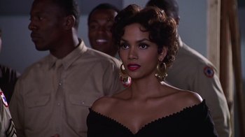 Movie still from “Introducing Dorothy Dandridge” (1999), directed by Martha Coolidge – A woman in a black dress and some other people in the background; Close Up shot, Over the shoulder angle