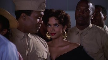 Movie still from “Introducing Dorothy Dandridge” (1999), directed by Martha Coolidge – A man and a woman standing next to each other in front of another man; Close Up shot, Over the shoulder angle