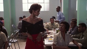 Movie still from “Introducing Dorothy Dandridge” (1999), directed by Martha Coolidge – A group of people sitting around a table; Medium shot, Over the shoulder angle