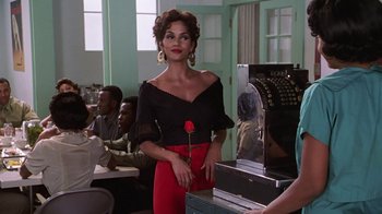 Movie still from “Introducing Dorothy Dandridge” (1999), directed by Martha Coolidge – A woman standing in front of a cash register; Medium shot, Over the shoulder angle