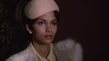 Movie still from “Introducing Dorothy Dandridge” (1999), directed by Martha Coolidge – A woman wearing a white hat and a fur coat; Close Up shot, Over the shoulder angle