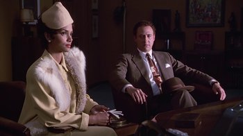 Movie still from “Introducing Dorothy Dandridge” (1999), directed by Martha Coolidge – A man and a woman sitting on a couch; Medium shot, Over the shoulder angle
